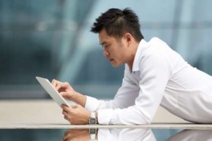 Asian Business man using a  touch pad PC