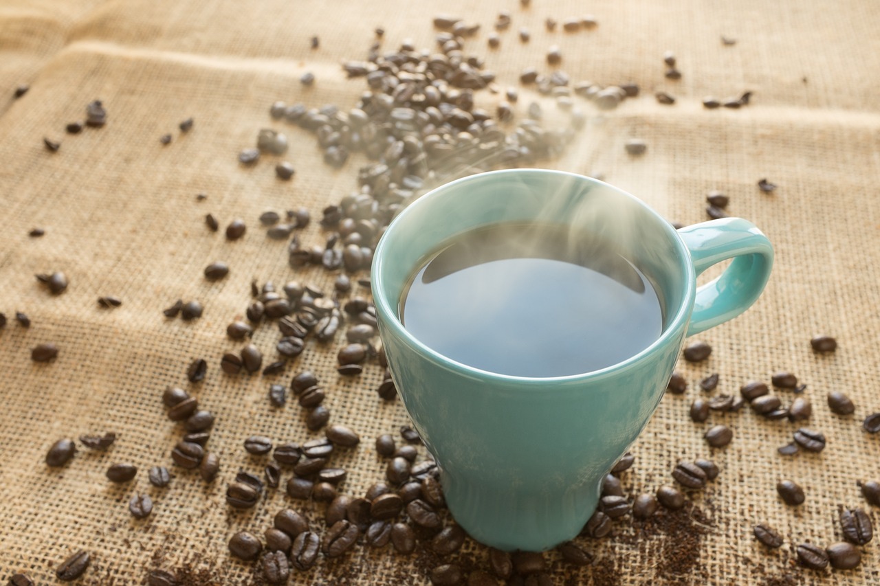 Hot coffee and coffee beans on the table