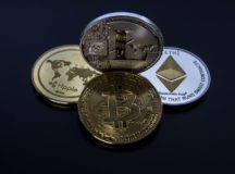 Four assorted cryptocurrency coins